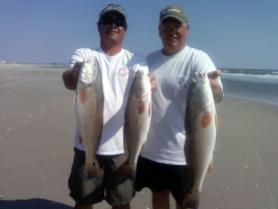 Jeff and Ben with red drum they caught on lures from the beach in Cape May co., NJ